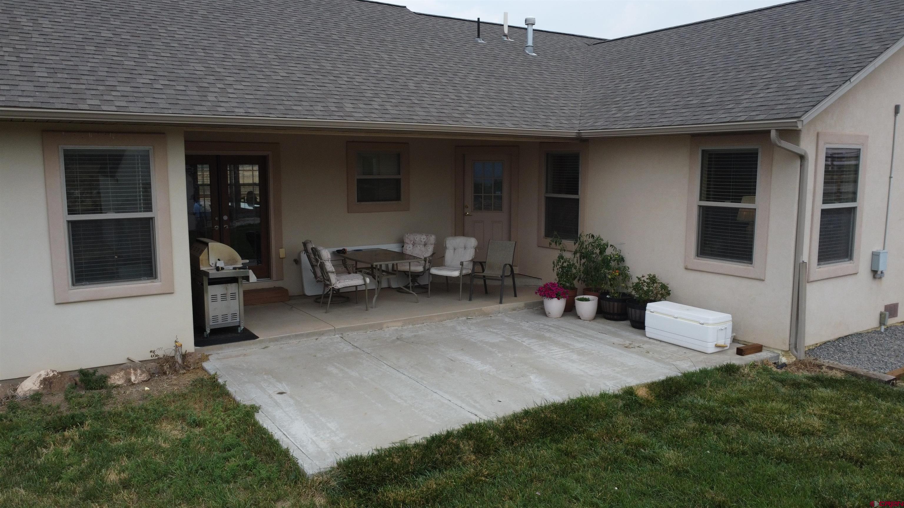 18200 Surface Creek Road Cedaredge, CO 81413 - Photo 5 of 39 a view of a house with backyard sitting area and garden