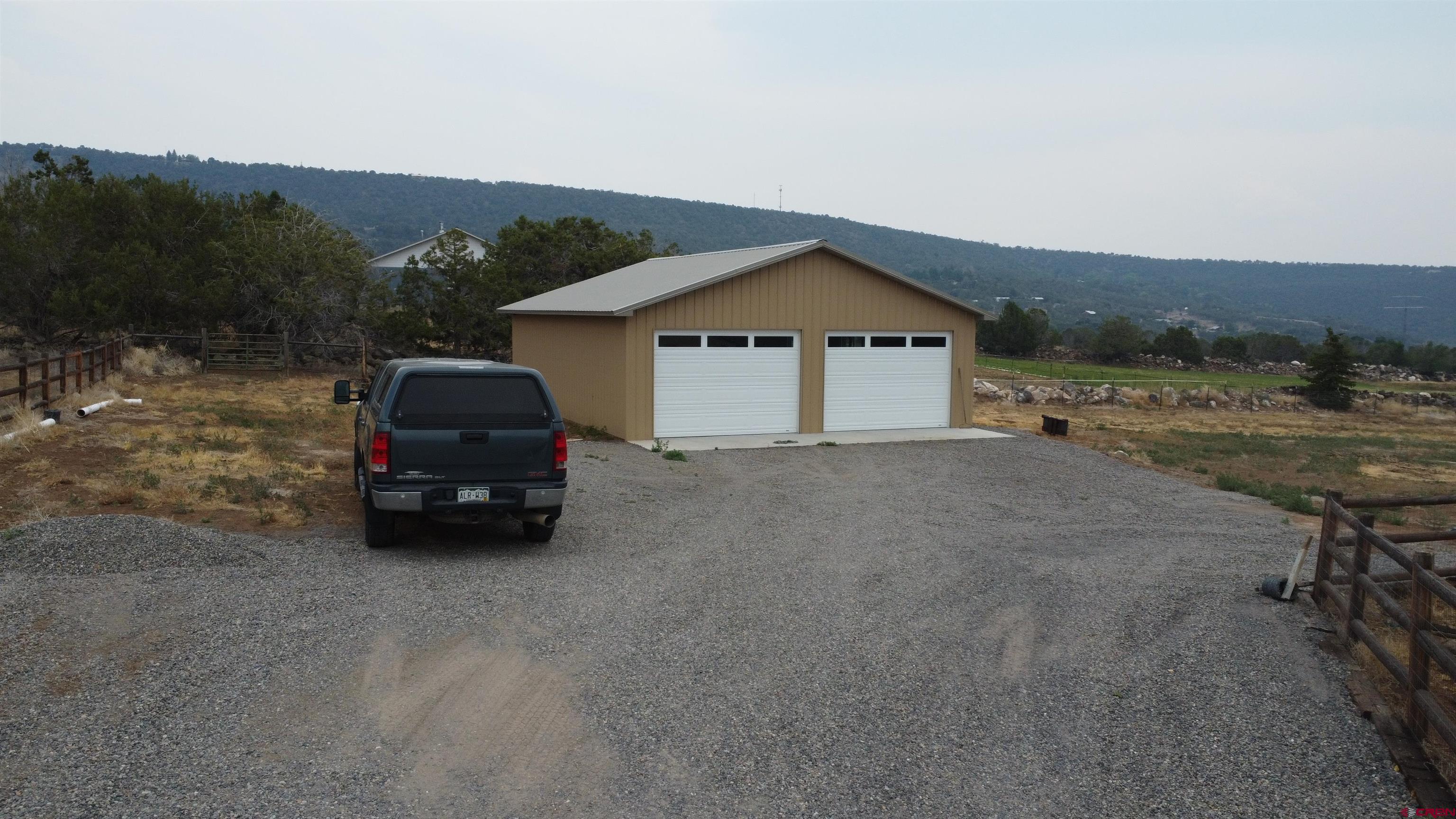 18200 Surface Creek Road Cedaredge, CO 81413 - Photo 8 of 39 a view of a car parked in front of a house