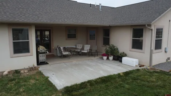a living room with furniture hard wood floor and a flat screen tv