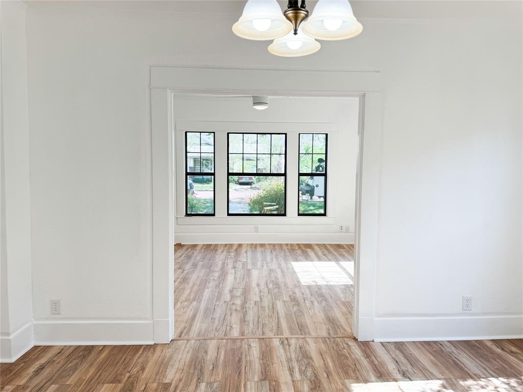 904 West 7th Street Cisco, TX 76437 - Photo 11 of 37 wooden floor in an empty room with a window