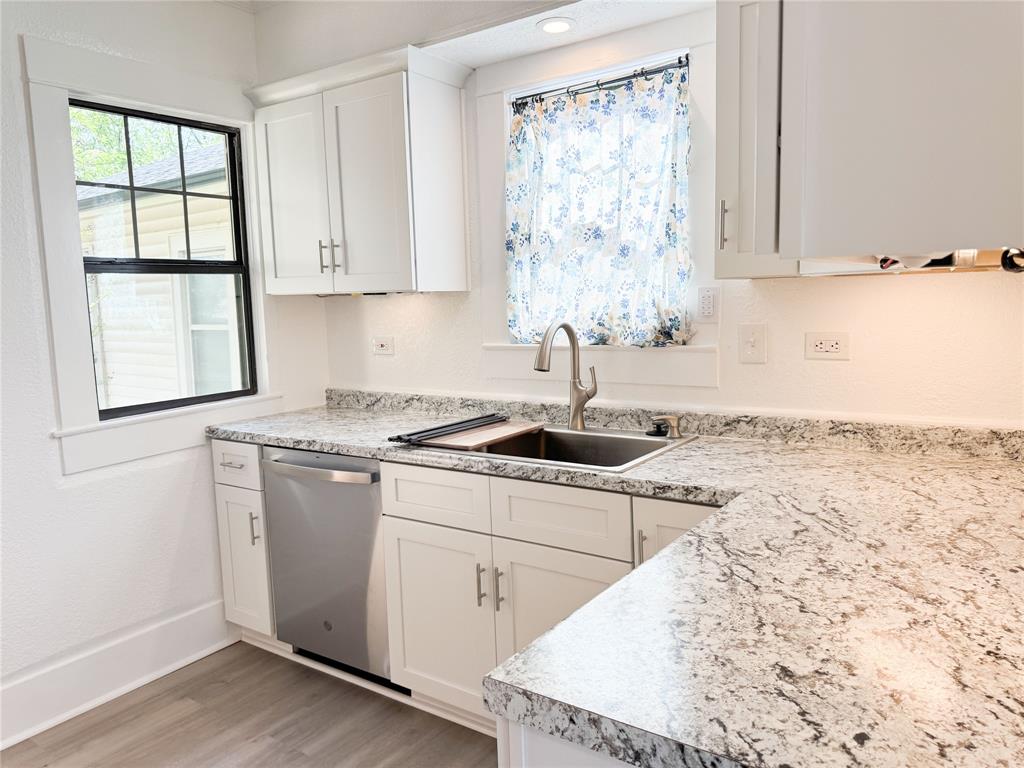 904 West 7th Street Cisco, TX 76437 - Photo 16 of 37 a kitchen with a sink stove and cabinets