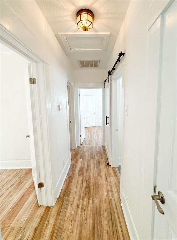 904 West 7th Street Cisco, TX 76437 - Photo 22 of 37 a view of a hallway with wooden floor and staircase
