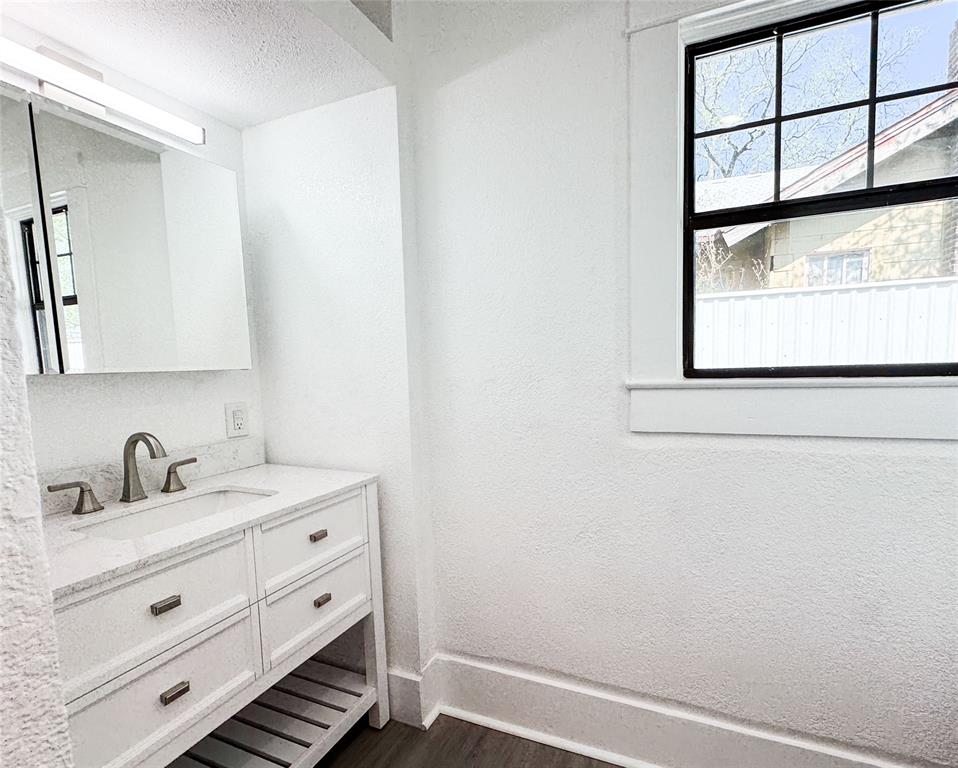 904 West 7th Street Cisco, TX 76437 - Photo 26 of 37 a bathroom with a sink and a mirror