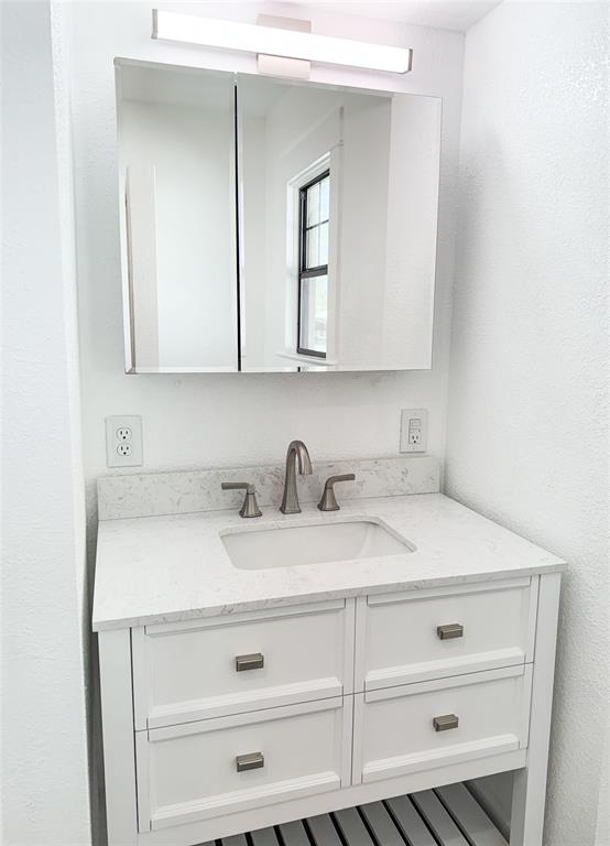 904 West 7th Street Cisco, TX 76437 - Photo 27 of 37 a bathroom with a sink and a mirror