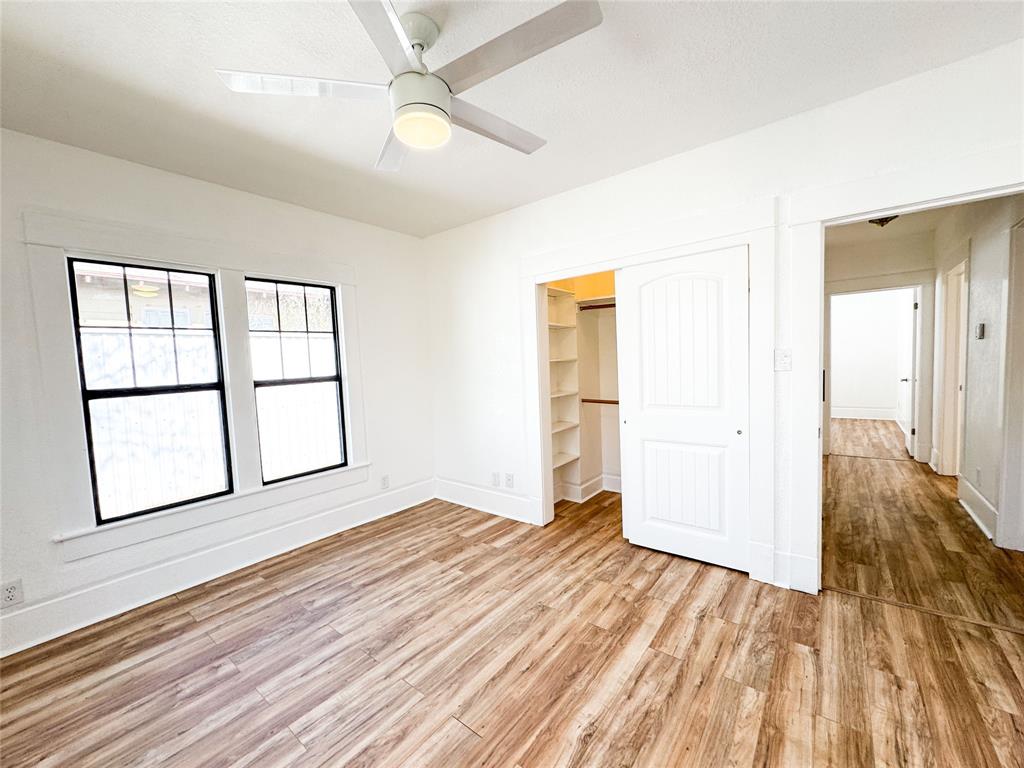 904 West 7th Street Cisco, TX 76437 - Photo 30 of 37 wooden floor in an empty room with a window