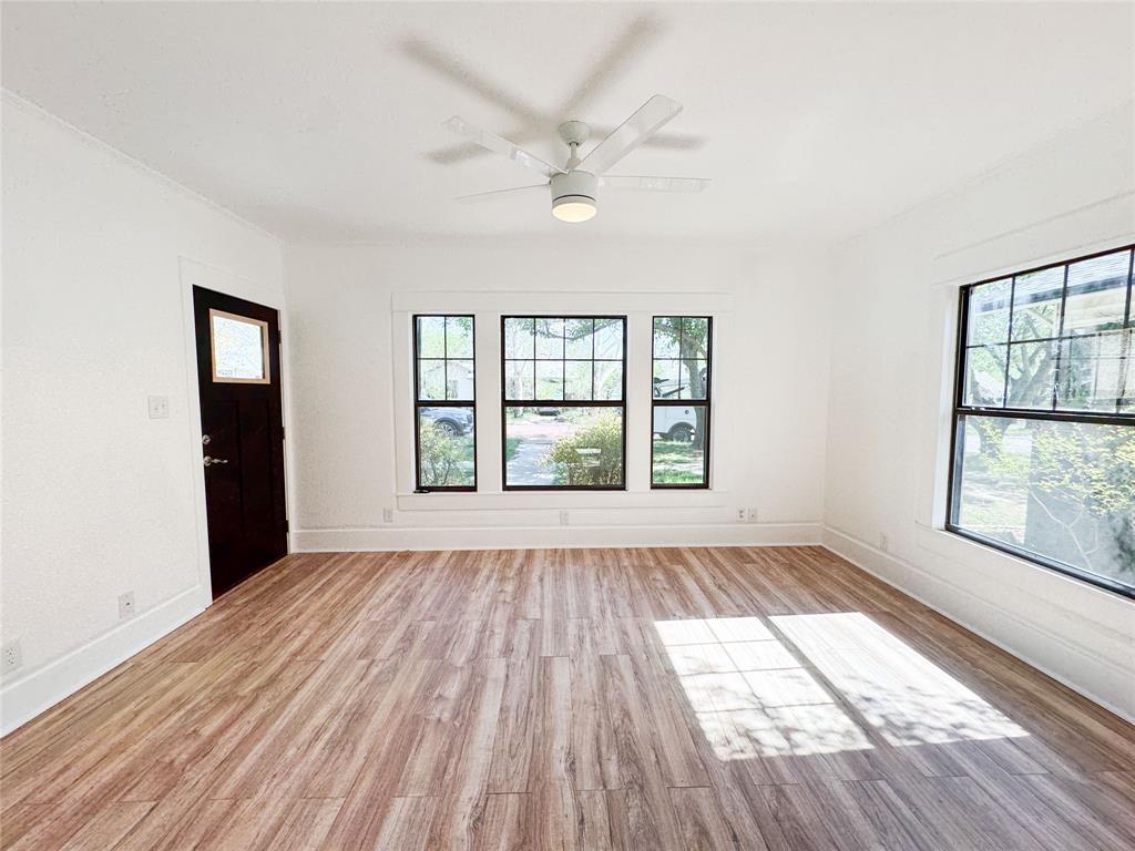 904 West 7th Street Cisco, TX 76437 - Photo 6 of 37 wooden floor in an empty room with a window