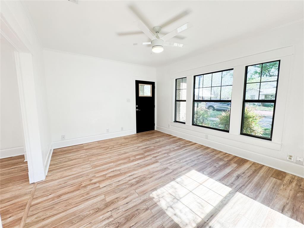 904 West 7th Street Cisco, TX 76437 - Photo 7 of 37 wooden floor in an empty room with a window