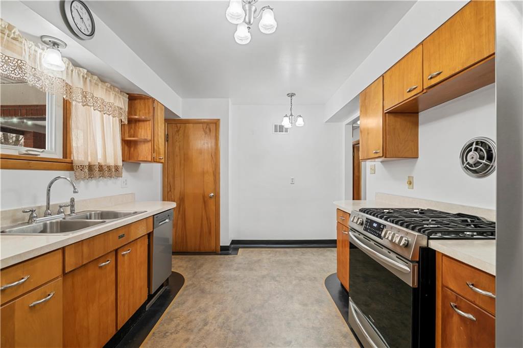 340 Carley Avenue Sharon, PA 16146 - Photo 12 of 28 a kitchen with stainless steel appliances granite countertop a stove a sink dishwasher and a refrigerator