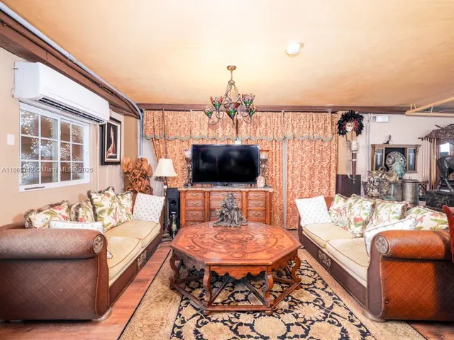 a dining room with furniture window and wooden floor