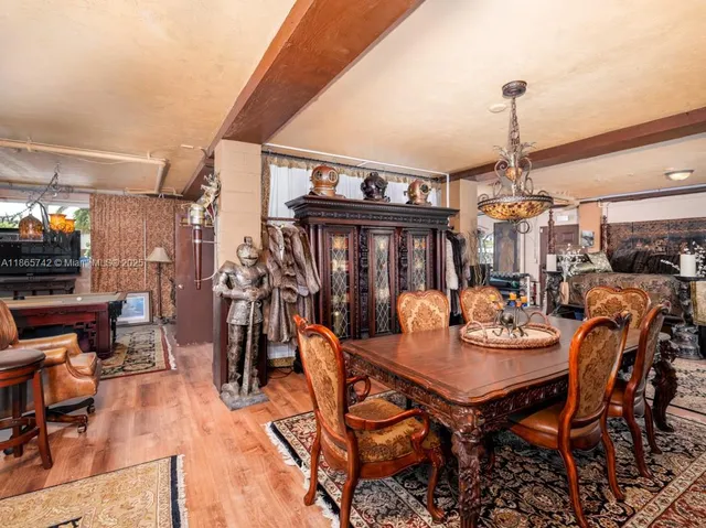 an aerial view of residential houses with outdoor space and trees