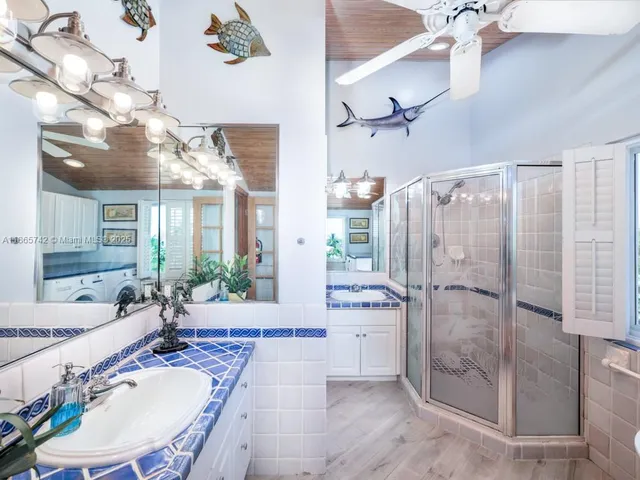 a bathroom with a sink mirror vanity and toilet