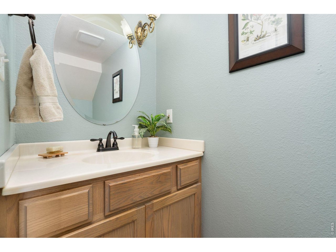 1055 Coho Run Fort Collins, CO 80524 - Photo 14 of 43 a bathroom with a sink vanity and mirror