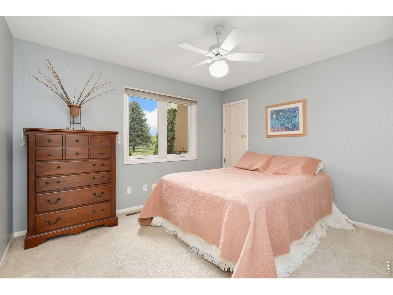 1055 Coho Run Fort Collins, CO 80524 - Photo 18 of 43 a bedroom with a bed and a dresser