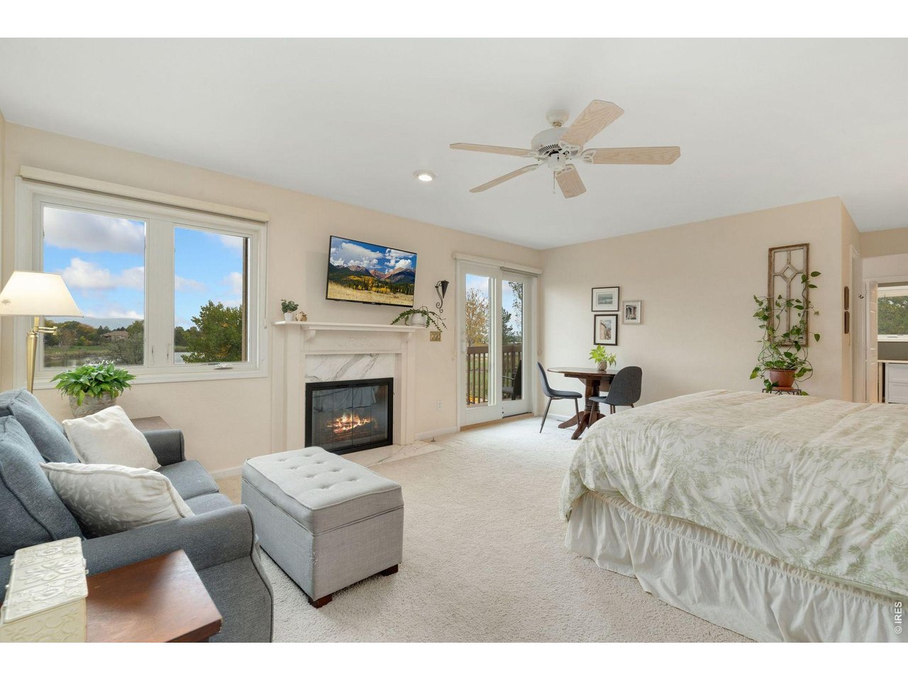 1055 Coho Run Fort Collins, CO 80524 - Photo 22 of 43 a living room with furniture a fireplace and a flat screen tv
