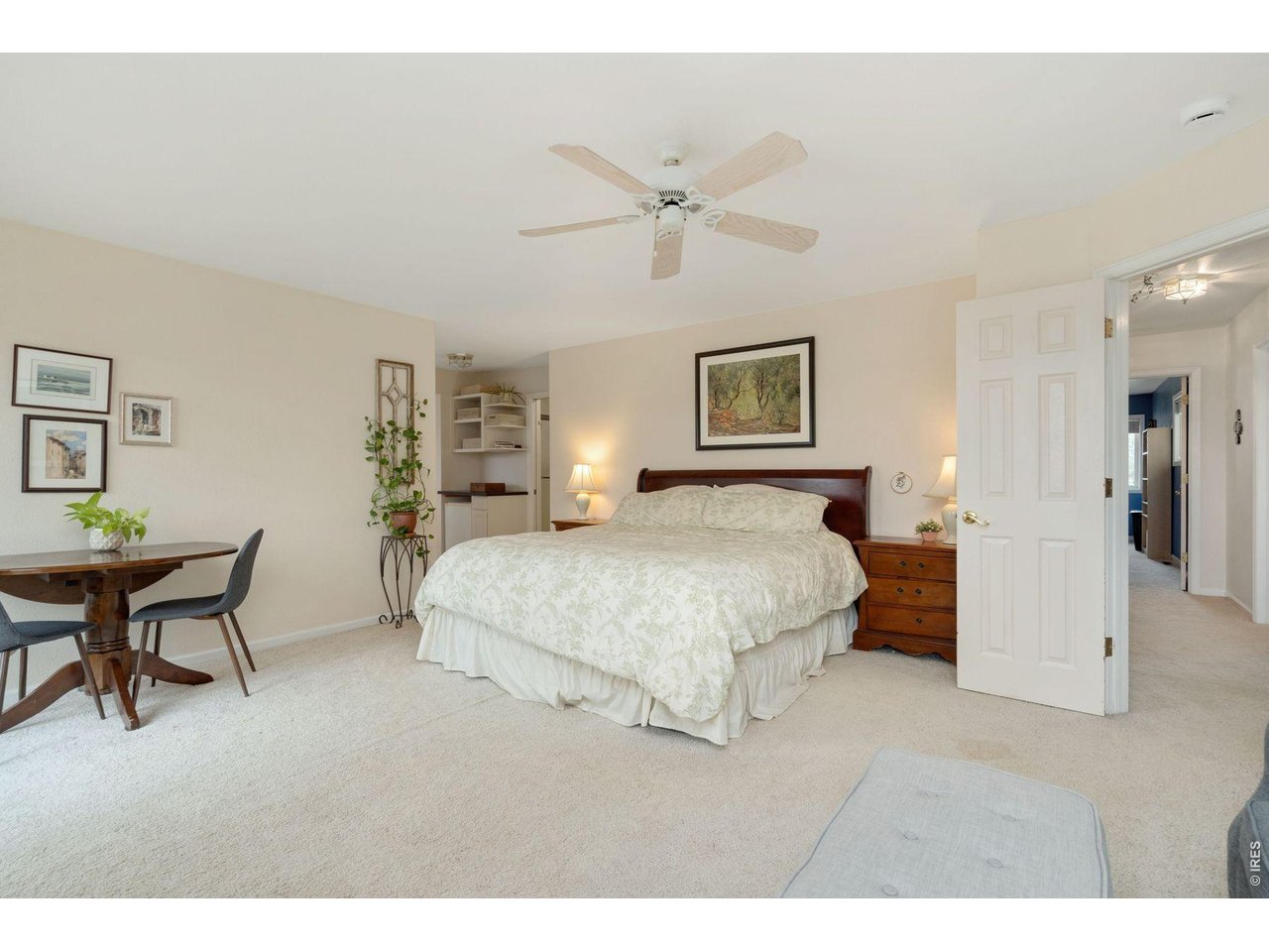1055 Coho Run Fort Collins, CO 80524 - Photo 23 of 43 a spacious bedroom with a bed a table and chair