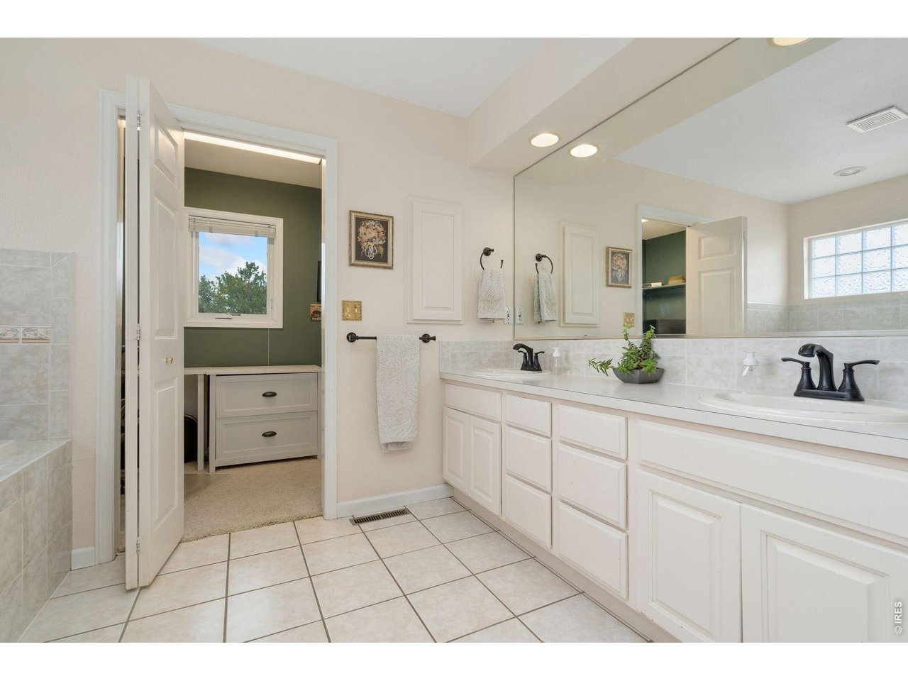 1055 Coho Run Fort Collins, CO 80524 - Photo 25 of 43 a bathroom with a sink a toilet and mirror