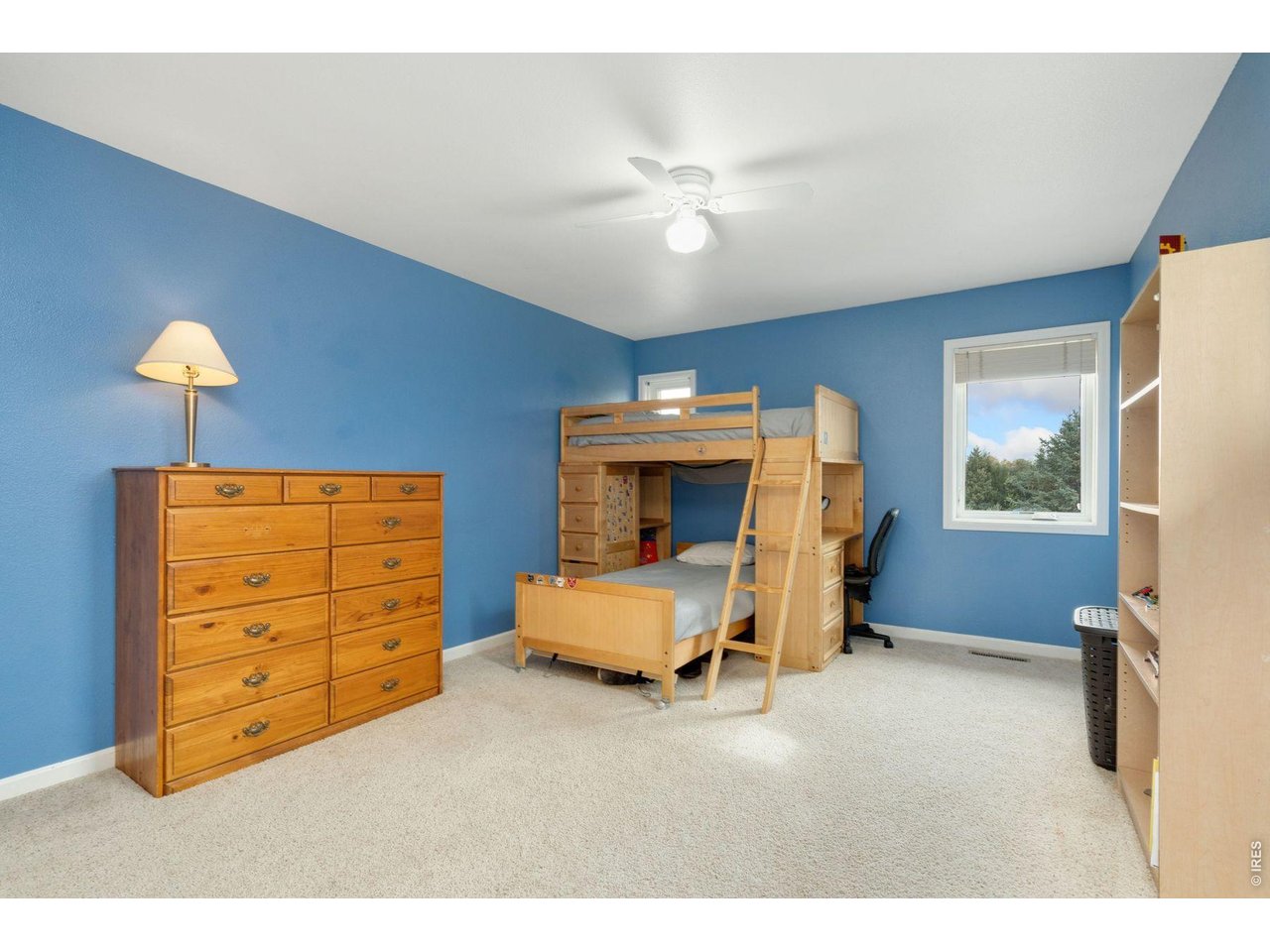 1055 Coho Run Fort Collins, CO 80524 - Photo 26 of 43 a bedroom with a bed and a mirror