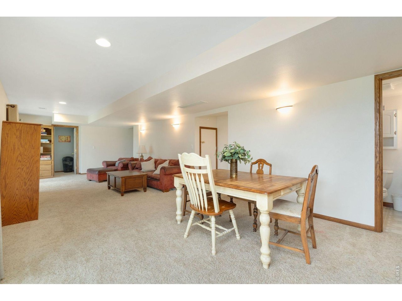 1055 Coho Run Fort Collins, CO 80524 - Photo 30 of 43 a dining room with furniture and a chandelier