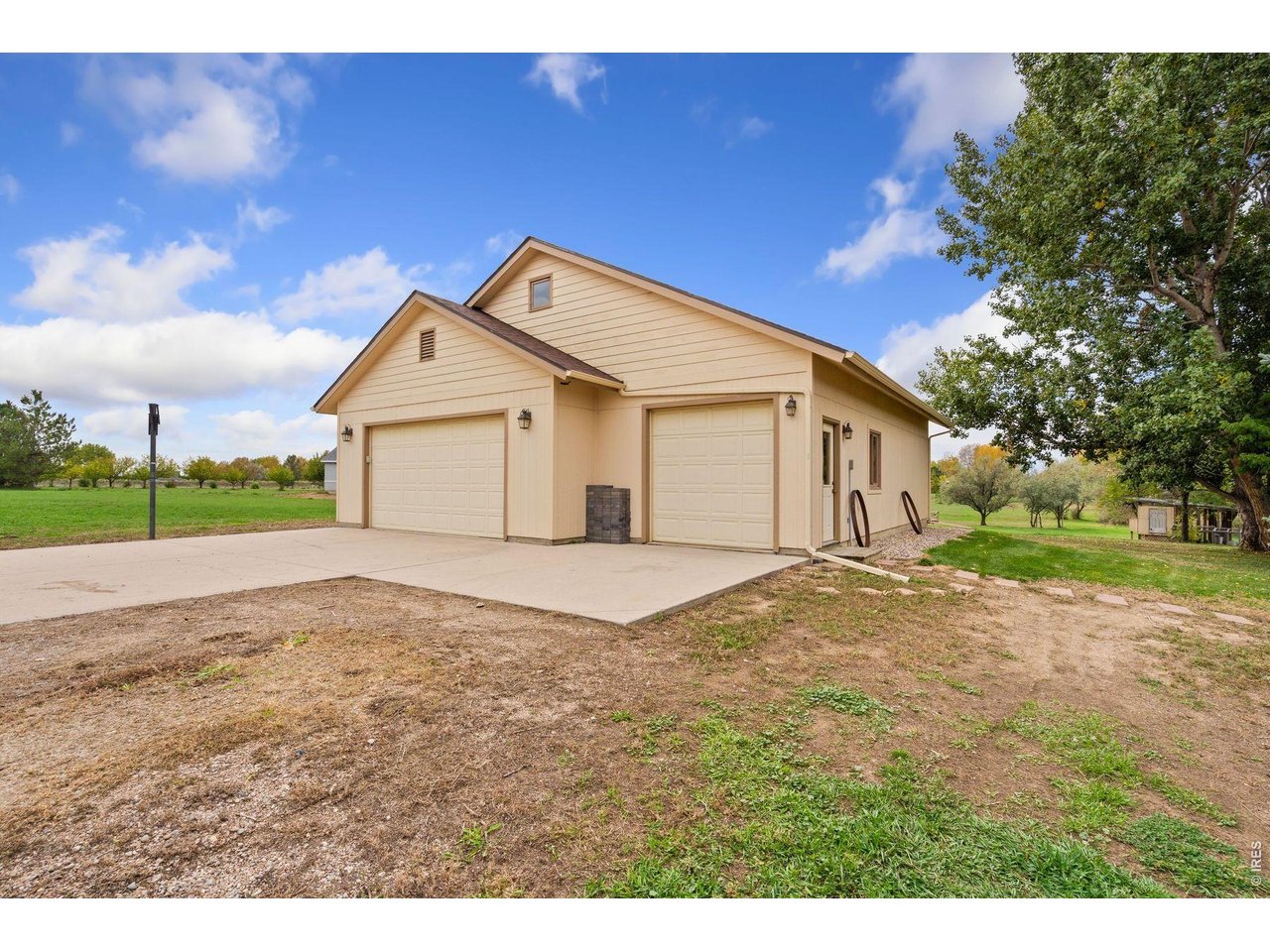 1055 Coho Run Fort Collins, CO 80524 - Photo 39 of 43 a view of a house with a yard and garage