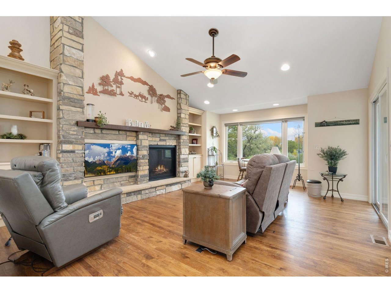 1055 Coho Run Fort Collins, CO 80524 - Photo 6 of 43 a living room with furniture a fireplace and a flat screen tv