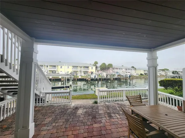 a view of a balcony with two chairs and a table