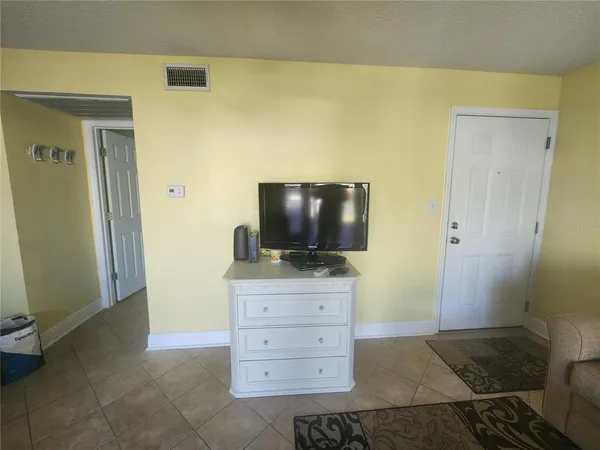 a kitchen with refrigerator and window