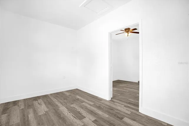 a view of a room with wooden floor