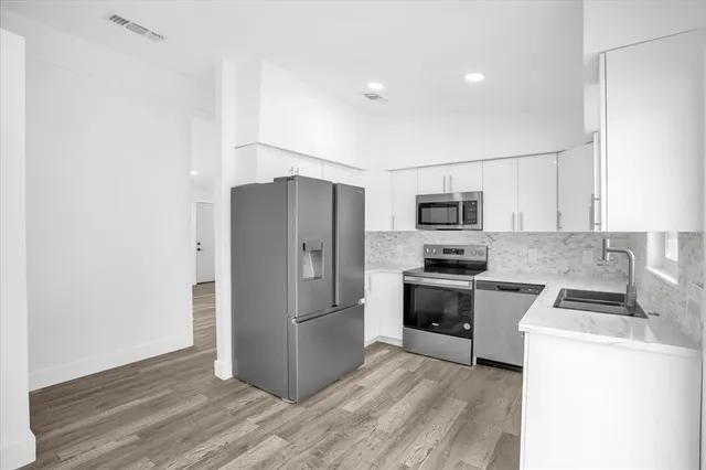 a kitchen with a refrigerator sink and microwave