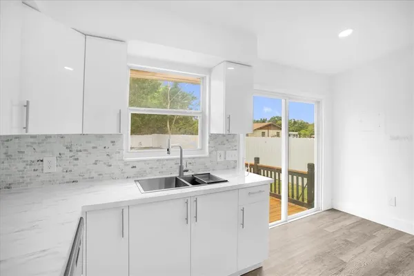 a kitchen with a sink and a refrigerator