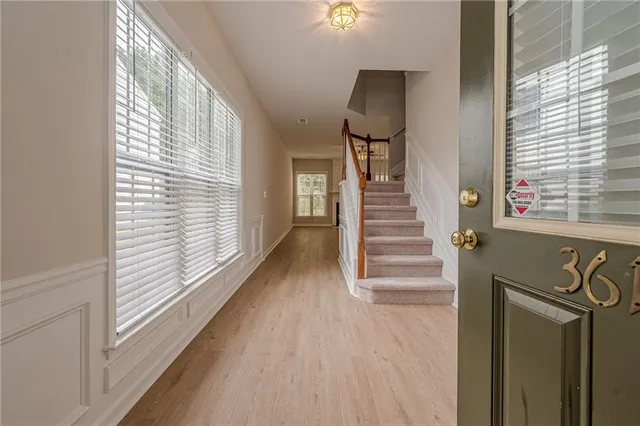 a view of a hallway with wooden floor