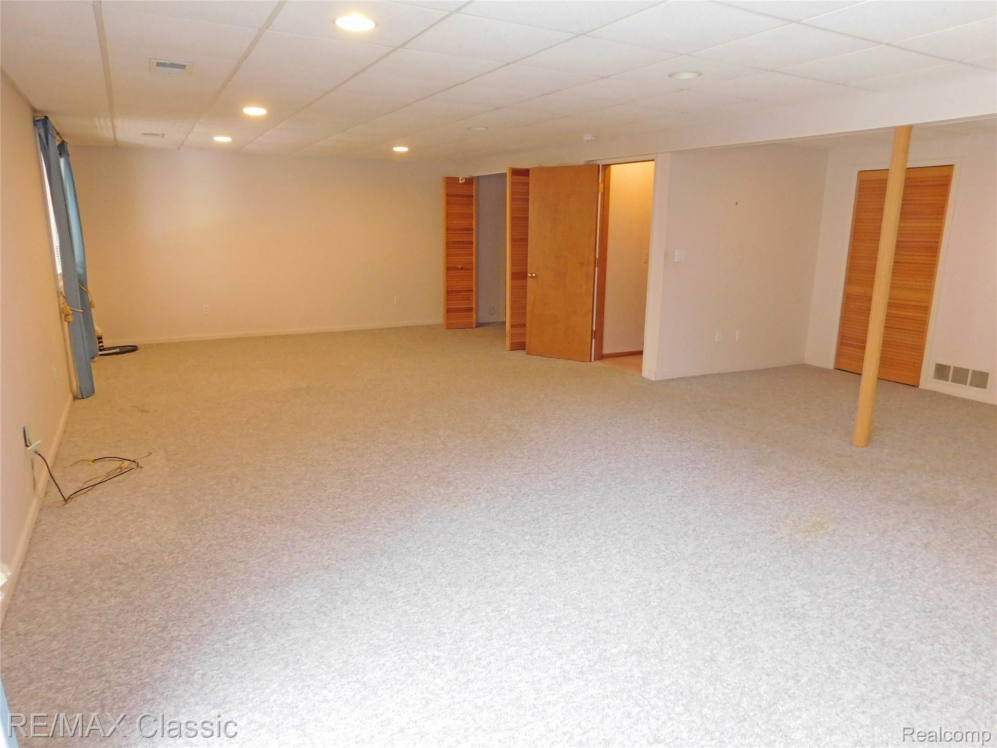 21840 River Ridge Trail, Unit 104 Farmington, MI 48335 - Photo 24 of 35 FABULOUS FINISHED WALK-OUT BASEMENT HAS BERBER CARPET, WET BAR, RECESSED LIGHTS AND 3RD FULL BATH AS WELL AS POSSIBLE 3RD BEDROOM OR OFFICE