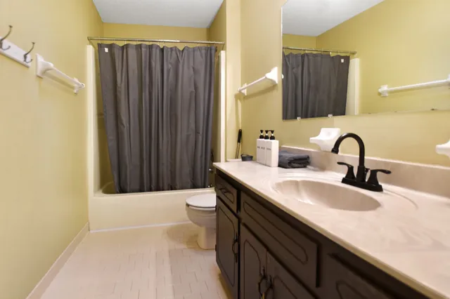 a bathroom with a sink a toilet and mirror