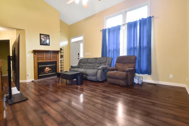 a living room with furniture and a fireplace
