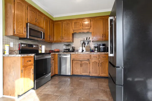 a kitchen with stove cabinets and a refrigerator