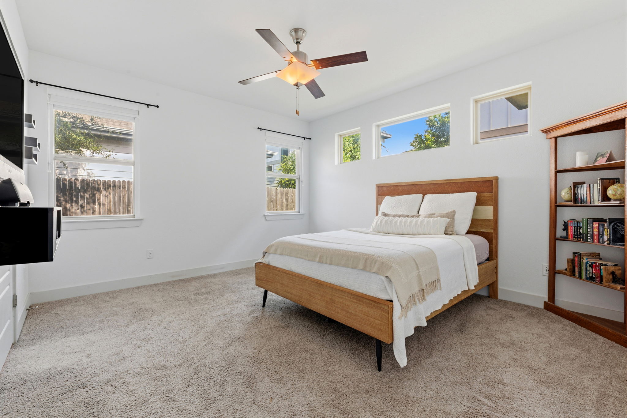 1007 Totis Road Austin, TX 78748 - Photo 22 of 37 a bedroom with a bed cabinets and window