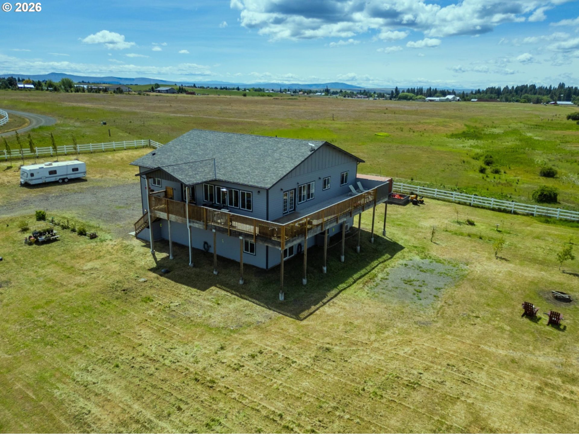 19 Inverness Road Goldendale, WA 98620 - Photo 5 of 48 a wooden bench sitting on top of a lake next to a building
