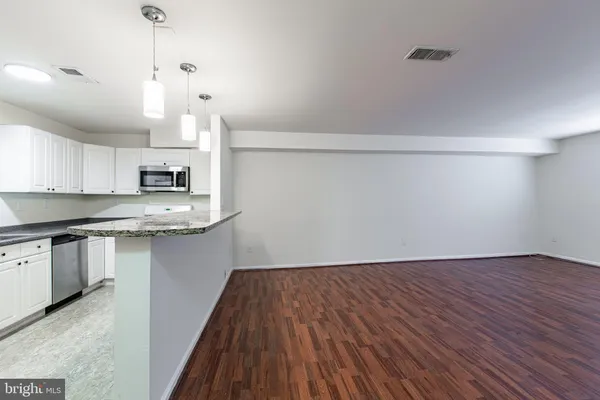 a kitchen with a hard wood floor