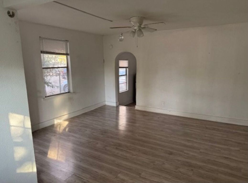 3207 Burleson Road, Unit 1 Austin, TX 78741 - Photo 2 of 11 a big room with wooden floor chandelier and windows