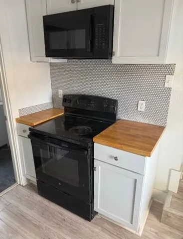 a stove top oven sitting inside of a kitchen