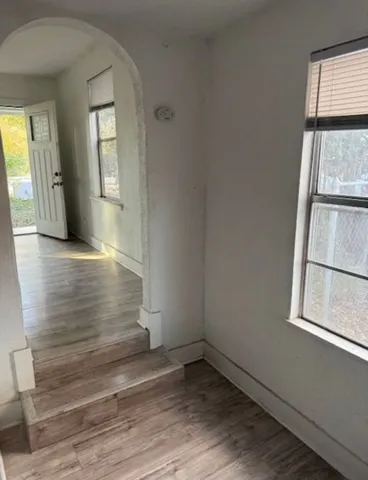 wooden floor in an empty room with a window