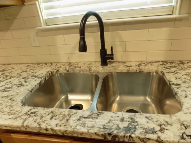 an outdoor sitting area with wooden floor