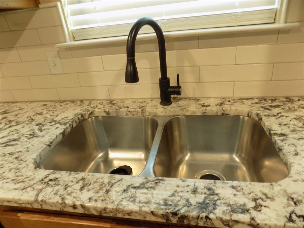 2007 Brown Loop Poolville, TX 76487 - Photo 11 of 32 a bathroom with a granite countertop sink