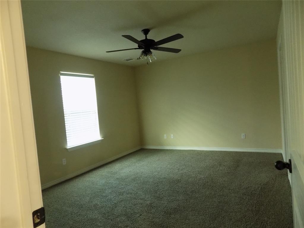 2007 Brown Loop Poolville, TX 76487 - Photo 16 of 32 an empty room with a window and a fan