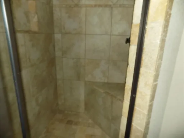 a bathroom with a granite countertop sink and a toilet