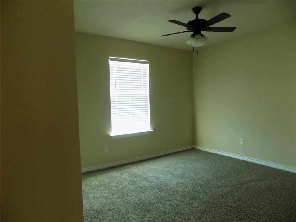 2007 Brown Loop Poolville, TX 76487 - Photo 26 of 32 an empty room with a window and a fan