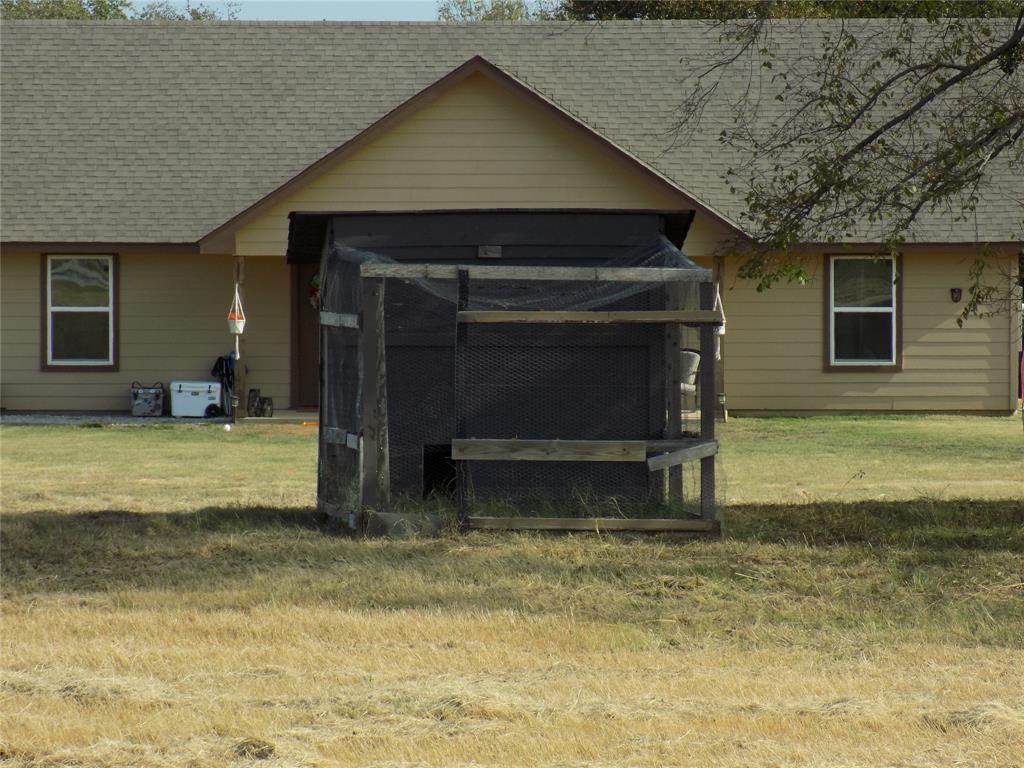 2007 Brown Loop Poolville, TX 76487 - Photo 28 of 32 a view of a house with a yard