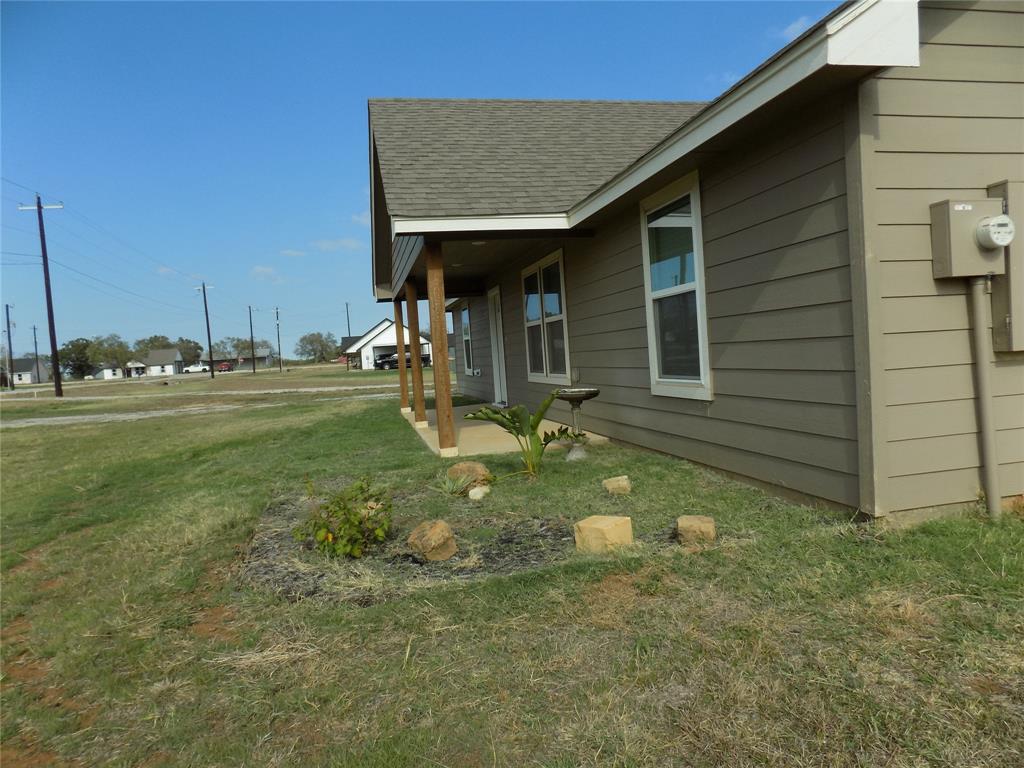 2007 Brown Loop Poolville, TX 76487 - Photo 31 of 32 a backyard of a house with table and chairs