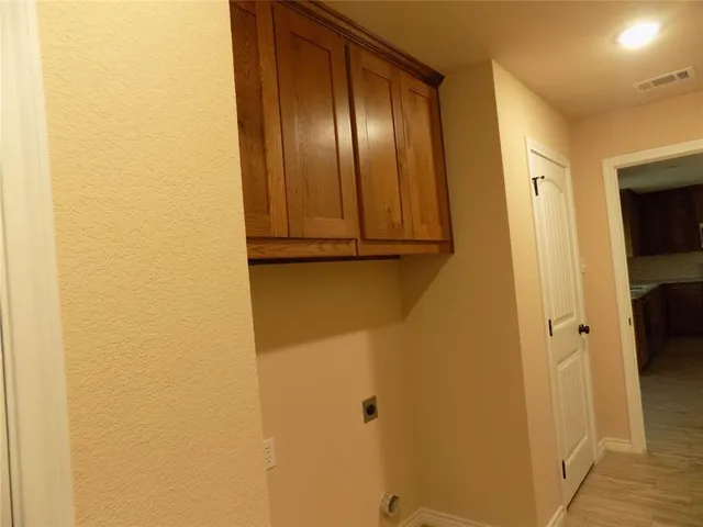 a large kitchen with stainless steel appliances granite countertop a stove a sink dishwasher and a refrigerator with wooden floor