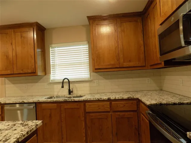 a bathroom with a granite countertop sink