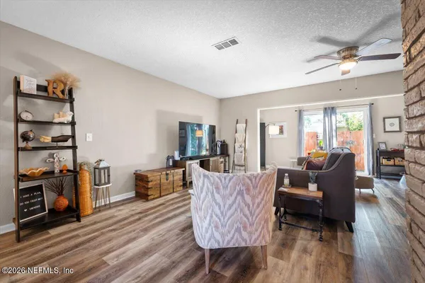 a living room with furniture and wooden floor
